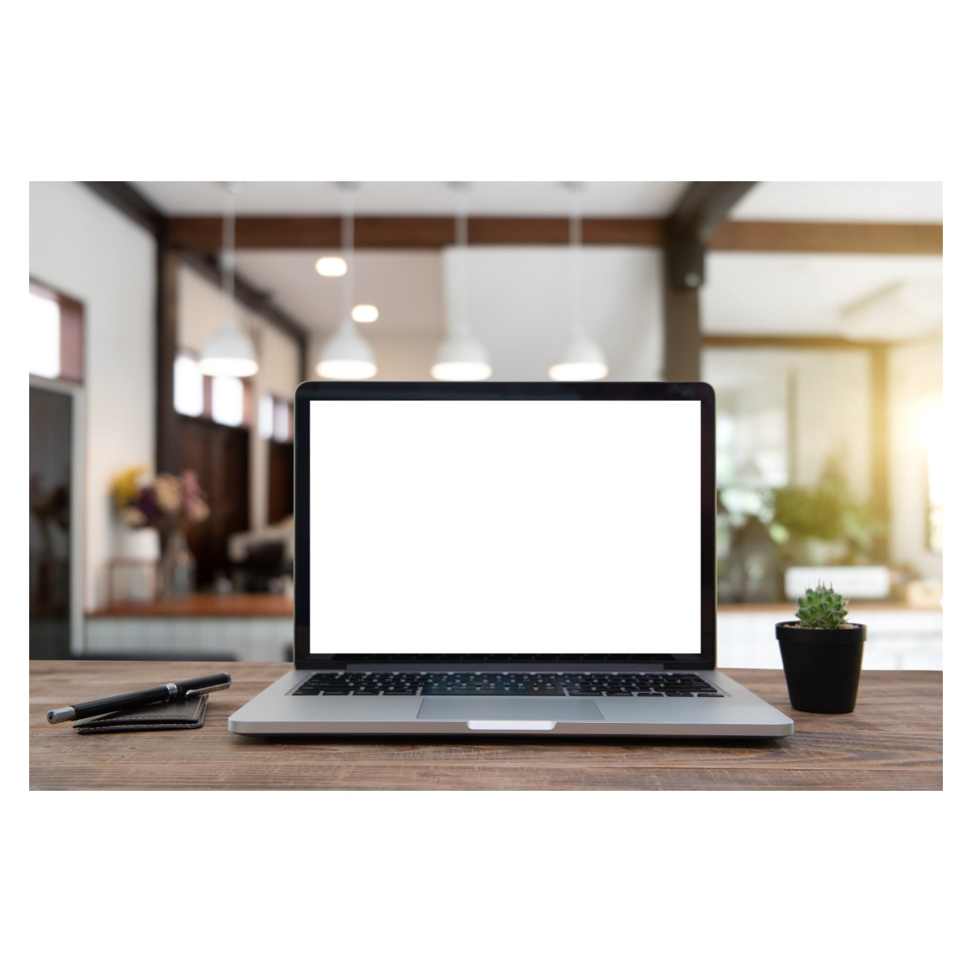 Laptop on a table beside a cup of coffee