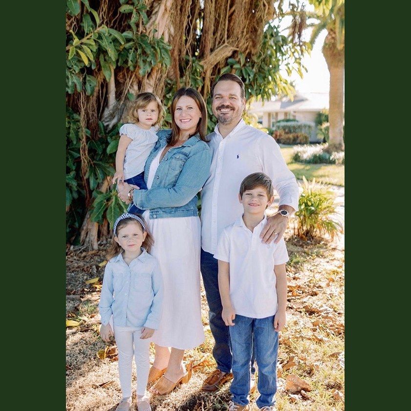 Chris and Allie Lopez with their three children under a banyan tree in Whiskey Creek